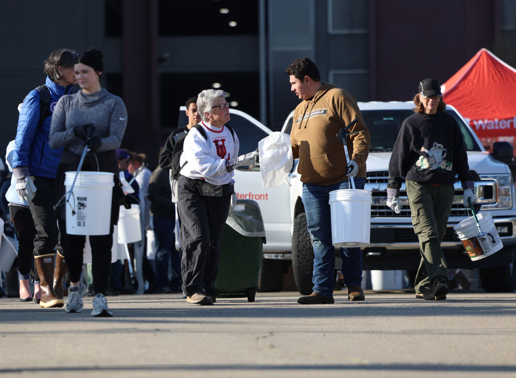 Volunteers receive buckets at Waterfront Park